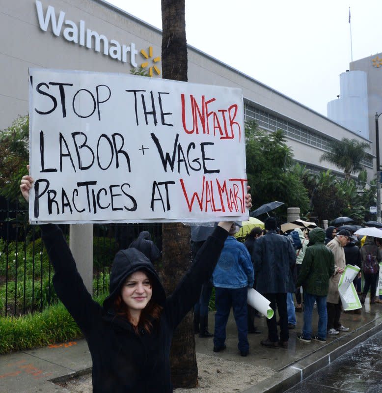 Protesters demand Walmart provide a living wage and full-time work as part of a nationwide Black Friday strike outside a Walmart store in the Crenshaw area of Los Angeles on November 29, 2013. On December 22, 2005, Walmart was ordered to pay more than 100,000 California employees $172 million for depriving them of breaks to eat. File Photo by Jim Ruymen/UPI
