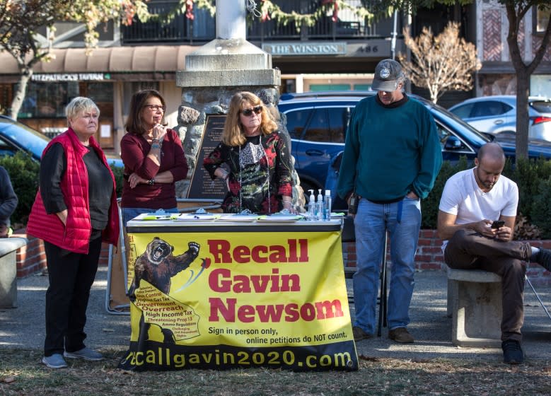 SOLVANG, CA - DECEMBER 20: People circulating a "Recall Gavin Newsom" petition listen to speakers decry a stolen election and demand the state open all businesses during an unsanctioned "Solvang MAGA Protest" in the park on December 20, 2020 in Solvang, California. Despite the rapidly rising surge of cases and deaths in California following Thanksgiving, tourists, primarily from Southern California and Los Angeles continue to be drawn to this Danish-themed Central Coast community each weekend. (Photo by George Rose/Getty Images)