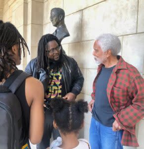  Former State Sen. Ernie Chambers talks to audience members Wednesday in a hallway of the Capitol where other Hall of Fame member busts are displayed. Chambers met with Malcolm X in the summer of 1964 when Malcolm X was in Omaha for a a speaking tour, according to the slain human rights leader’s daughter. (Cindy Gonzalez/Nebraska Examiner)