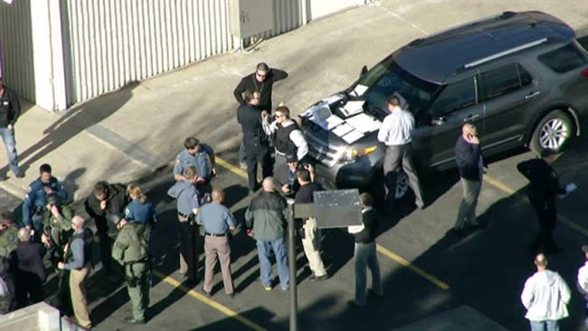 In this still image taken from video provided by Fox 31 Denver, police respond to reports of a shooting at Arapahoe High School in Centennial, Colo. Friday, Dec. 13, 2013. Colorado division of emergency management spokeswoman Micki Trost said her director went to the school and their weren't any more immediate details. (AP Photo/KDVR) MANDATORY CREDIT