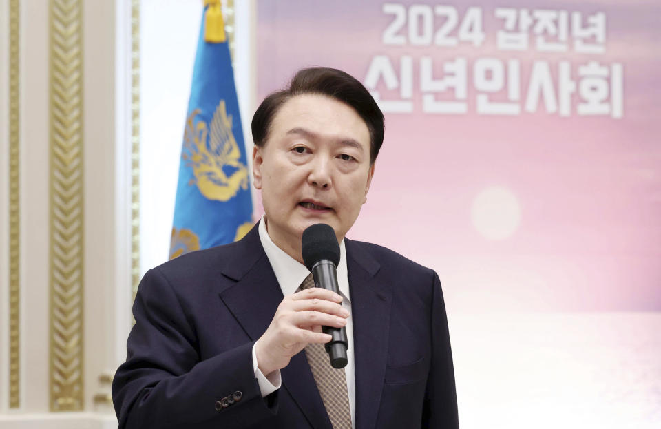 South Korean President Yoon Suk Yeol speaks during a New Year's meeting in Seoul, South Korea, Wednesday, Jan. 3, 2024. South Korea police have raided the residence and office of a man who stabbed the country’s opposition leader, Lee Jae-myung, in the neck this week. (Korea Pool/Yonhap via AP)