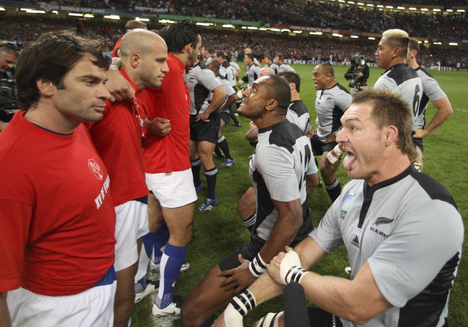 FILE - French players, left, stand close to their New Zealand counterparts who perform their pre-match Haka before the Rugby World Cup quarterfinal match between France and New Zealand at the Millennium Stadium in Cardiff, Wales, on Oct. 6, 2007. New Zealand rugby teams have been performing the haka before matches for 135 years. (AP Photo/Ross Land, Pool, File)