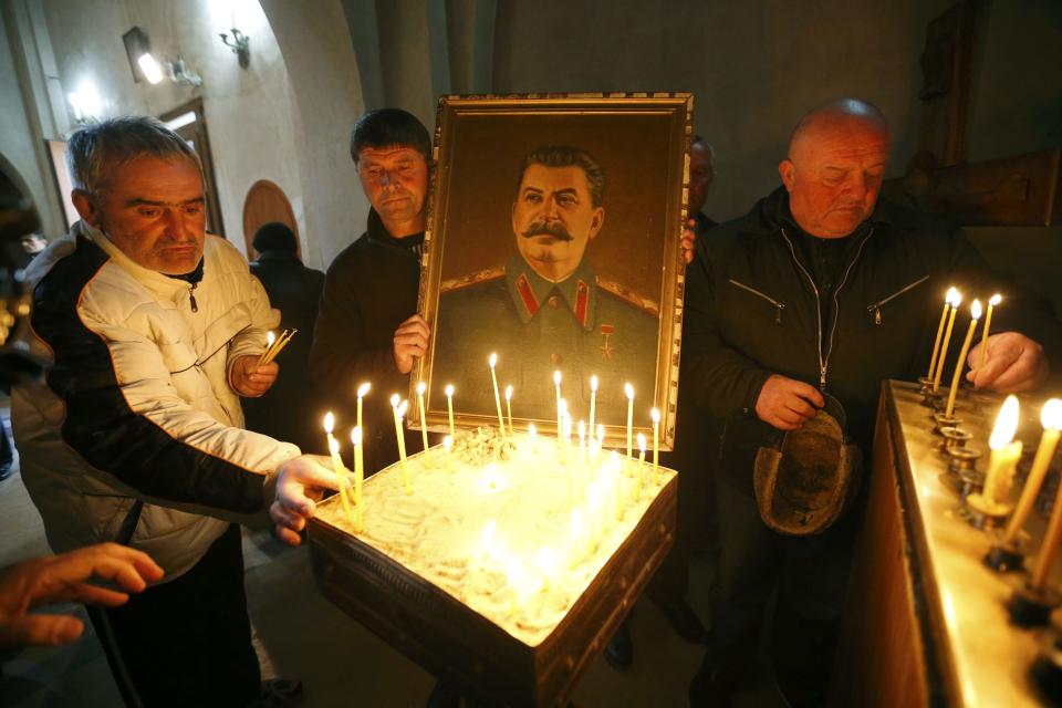 People place candles inside a church during a gathering to mark the anniversary of Soviet leader Joseph Stalin’s death in his hometown of Gori, Georgia, March 5, 2017. REUTERS/David Mdzinarishvili