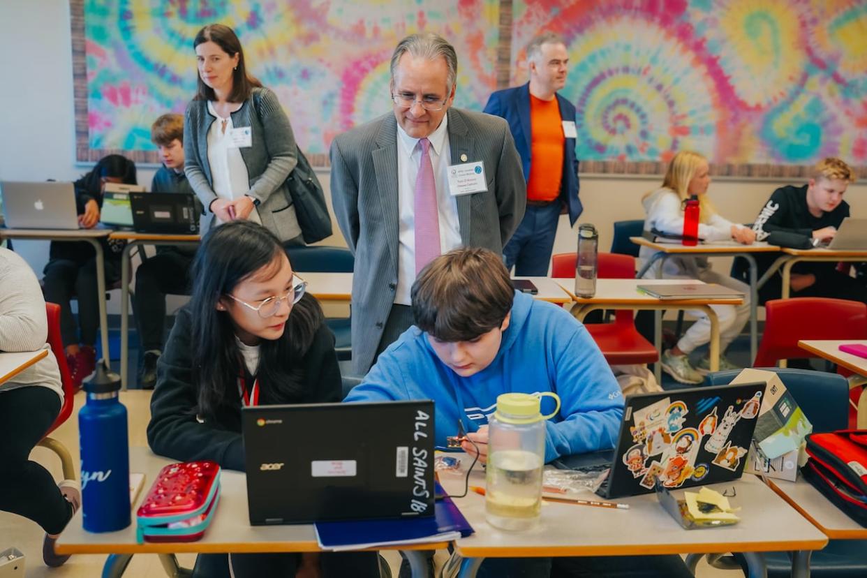 OCSB director of education Tom D'Amico, centre, believes AI education could allow students to think critically about digital content and social issues. (Ottawa Catholic School Board - image credit)