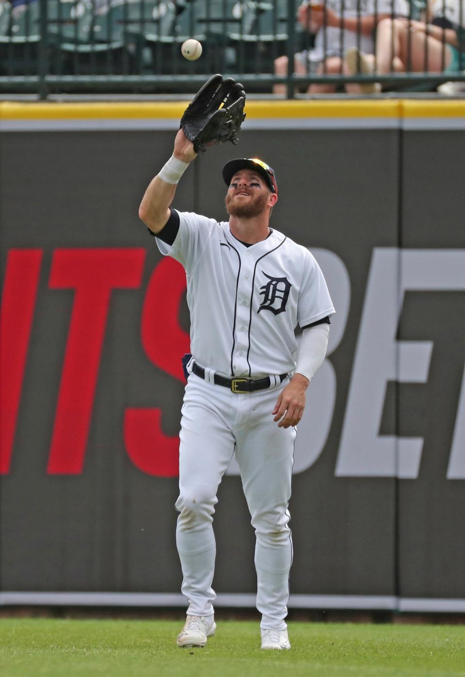 Detroit Tigers right fielder Robbie Grossman (8) catches a fly ball hit by Colorado Rockies shortstop Alan Trejo (13) during second-inning action on Sunday, April 24, 2022, at Comerica Park in Detroit.
