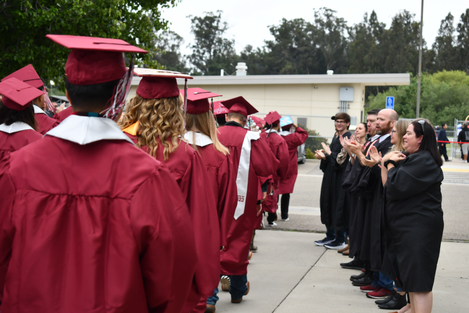 Nipomo High School grads walk while teachers clapped during a commencement ceremony on June 9.