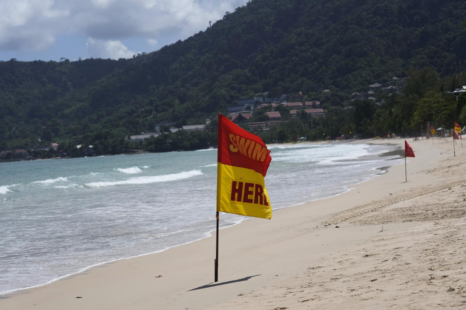 Swim markers line the empty tourist Patong Beach on Phuket, southern Thailand, Tuesday, June 29, 2021. Thailand's government will begin the "Phuket Sandbox" scheme to bring the tourists back to Phuket starting July 1. Even though coronavirus numbers are again rising around the rest of Thailand and prompting new lockdown measures, officials say there's too much at stake not to forge ahead with the plan to reopen the island to fully-vaccinated travelers. (AP Photo/Sakchai Lalit)