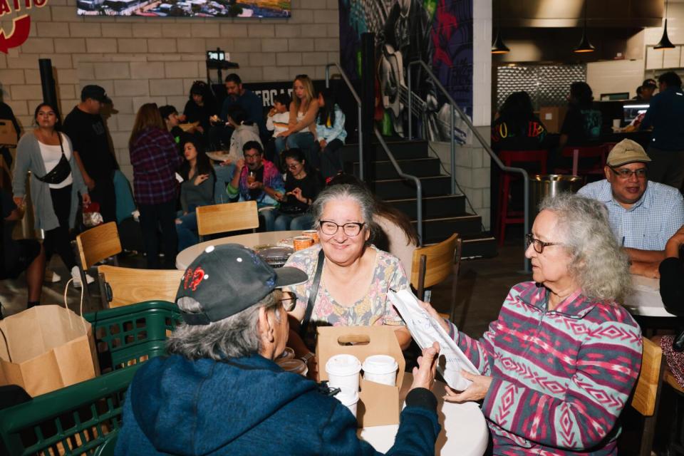 Fermin Ramirez, Rita Gomez and Isabel Gomez, left to right, chat on the communal tables at Mercado González Northgate Market
