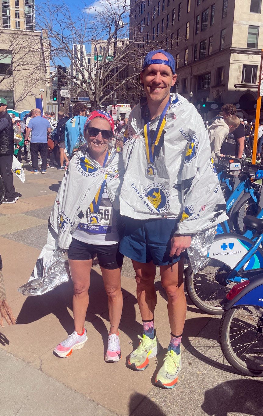 Laurie Dymond, left, of Chambersburg, Pa., and Bryan Seifarth, of Hagerstown, meet after finishing the 128th Boston Marathon on Monday, April 15, 2024.