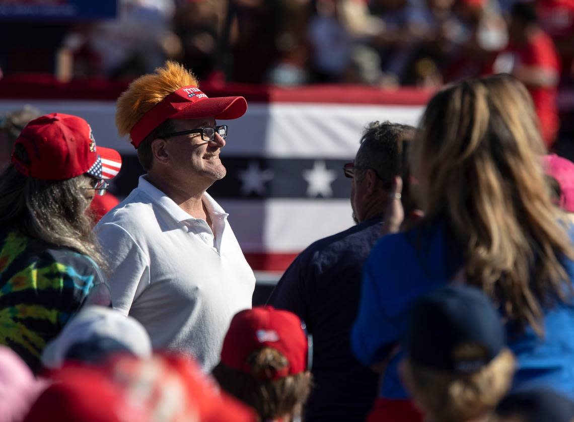 A person wears a hat to support former president Donald Trump prior to the start of a rally at Wilmington International Airport on Friday, Sept. 23, 2022.