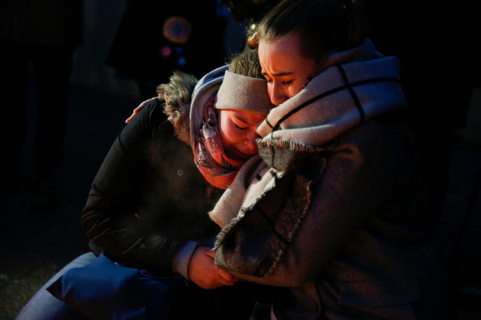 Women mourn at the scene of the Berlin Christmas market attack
