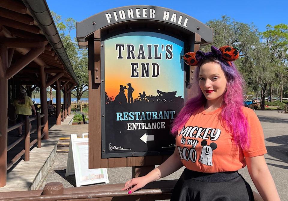 Trail's End at Disney World with the writer in front of the sign