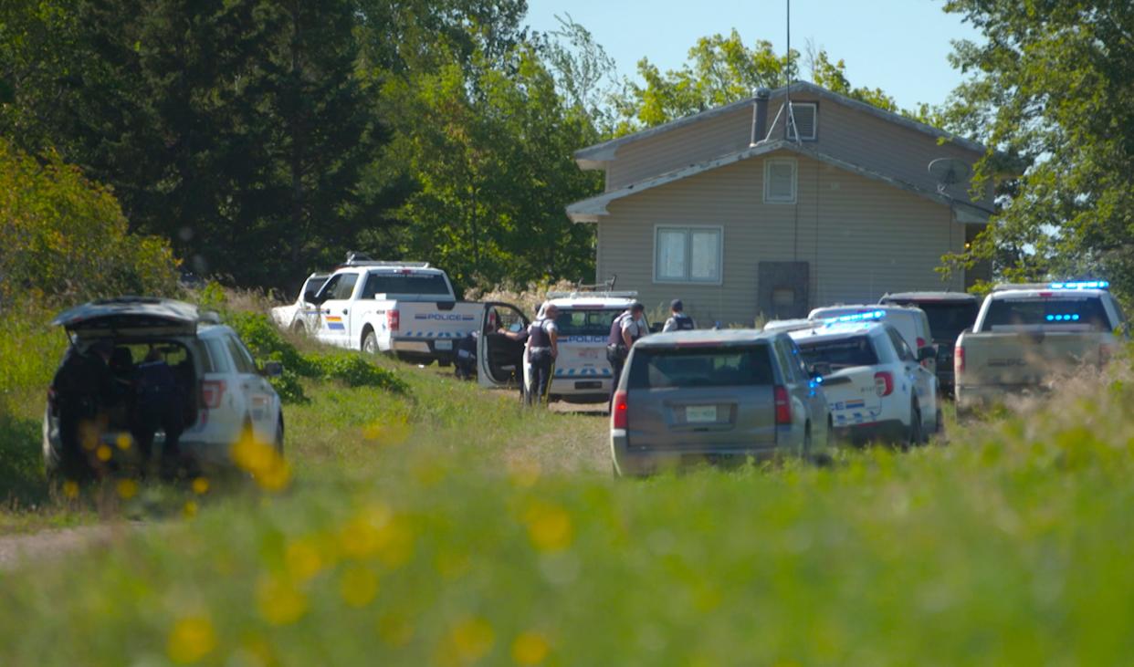 In this image taken from video, Canadian law enforcement personnel surrounded a residence on the James Smith Cree First Nation reservation in Saskatchewan, Canada, Tuesday, Sept. 6, 2022.