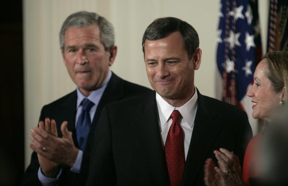 U.S. President George W. Bush, left, applauds as John Roberts, center, stands with his wife, Jane, after Roberts was sworn in as the 17th chief justice of the United States on Sept. 29, 2005. <a href="https://www.gettyimages.com/detail/news-photo/president-george-w-bush-left-applauds-as-john-roberts-news-photo/525584818?adppopup=true" rel="nofollow noopener" target="_blank" data-ylk="slk:Brooks Kraft LLC/Corbis via Getty Images;elm:context_link;itc:0;sec:content-canvas" class="link ">Brooks Kraft LLC/Corbis via Getty Images</a>