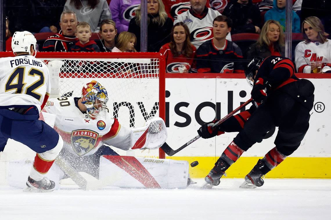 Carolina Hurricanes’ Brett Pesce (22) has his shot go wide of Florida Panthers goaltender Spencer Knight (30) during the first period of an NHL hockey game in Raleigh, N.C., Friday, Dec. 30, 2022. (AP Photo/Karl B DeBlaker)