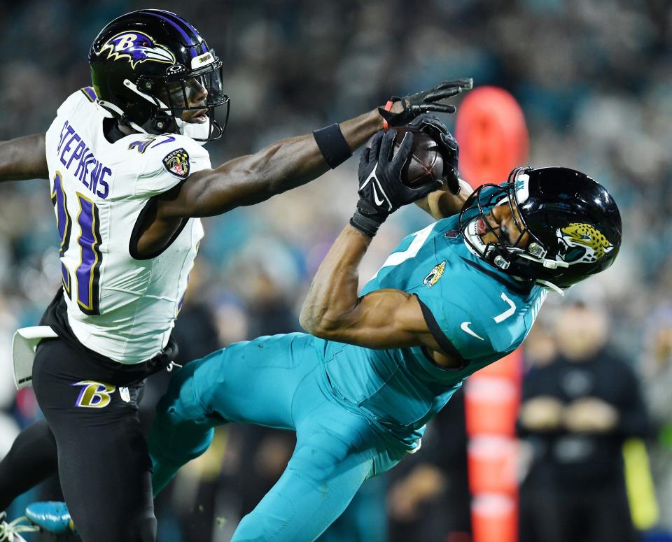 Jacksonville Jaguars wide receiver Zay Jones (7) pulls in a pass on the 5-yard-line while being defended by Baltimore Ravens cornerback Brandon Stephens (21) in the closing seconds of the half. The Jacksonville Jaguars hosted the Baltimore Ravens at EverBank Stadium in Jacksonville, Florida Sunday Night, December 17, 2023. The Jaguars trailed 10 to 0 at the half. [Bob Self/Florida Times-Union]