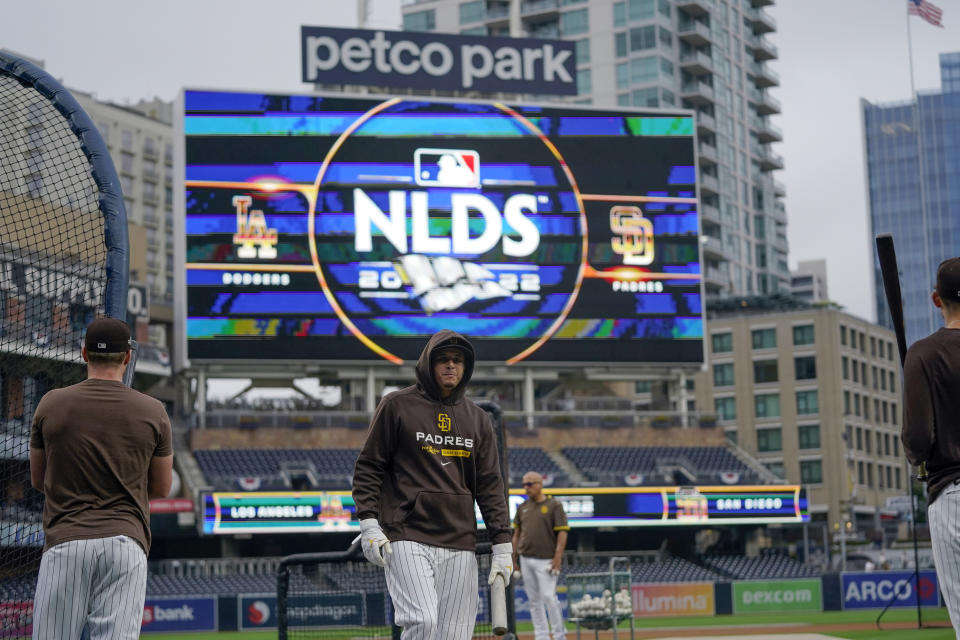 San Diego Padres third baseman Manny Machado, center, leaves the batting cage during a baseball workout Thursday, Oct. 13, 2022, in San Diego. The Padres host the Los Angeles Dodgers for Game 3 of an NL Division Series on Friday. (AP Photo/Gregory Bull)