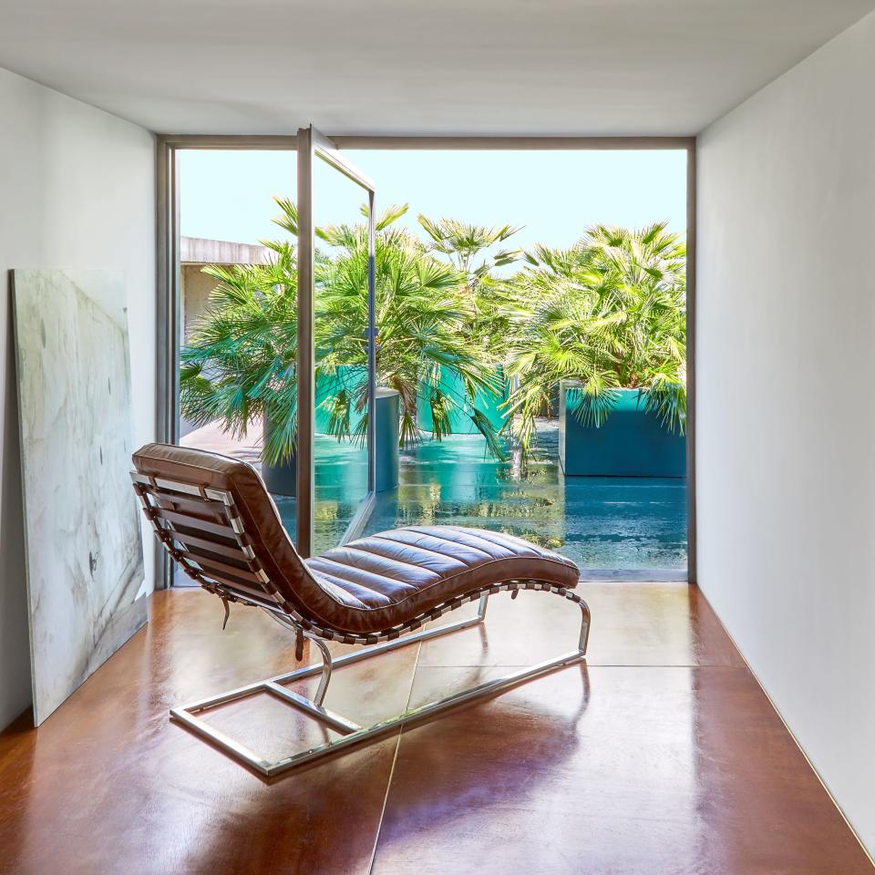 From a nook in the master bath, a vintage leather chaise longue overlooks the terrace.