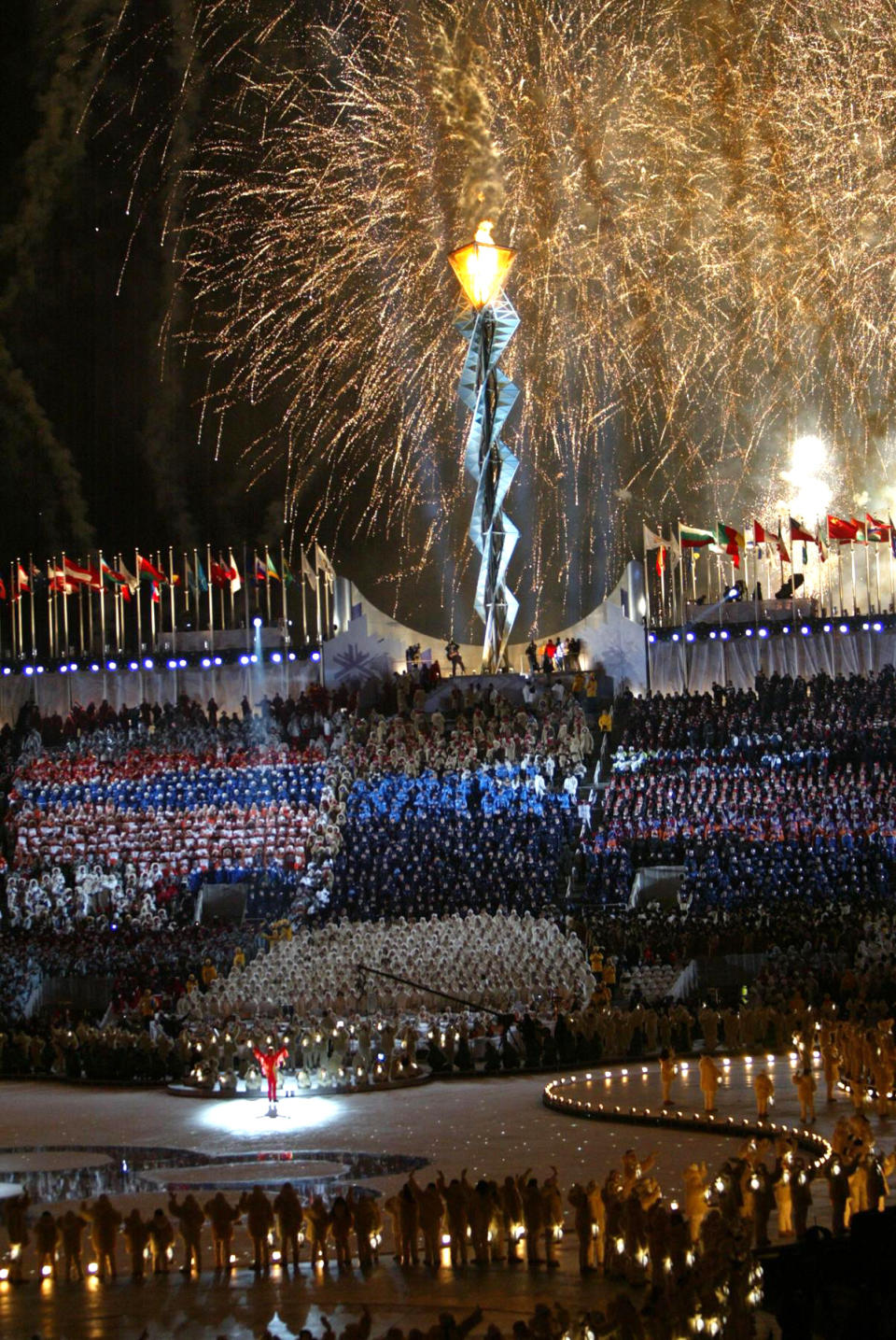 <p>In Salt Lake City, the Olympic torch and fireworks lit up the night sky above Rice-Eccles Stadium to celebrate the opening of the 2002 Olympics. (Getty) </p>