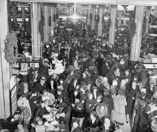 1932 Overlooking a crowd of Christmas shoppers near the information booth at Macy's.