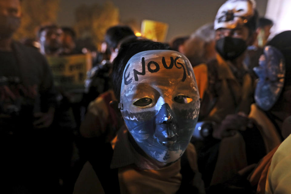 A child sports a mask with the words 'Enough' during a protest against the alarming levels of pollution in the city, near the India Gate monument in New Delhi, India, Tuesday, Nov. 5, 2019. The 20 million residents of New Delhi, already one of the world's most polluted cities, have been suffering for weeks under a toxic haze that is up to 10 times worse than the upper limits of what is considered healthy. The pollution crisis is piling public pressure on the government to tackle the root causes of the persistent haze. (AP Photo/Manish Swarup)