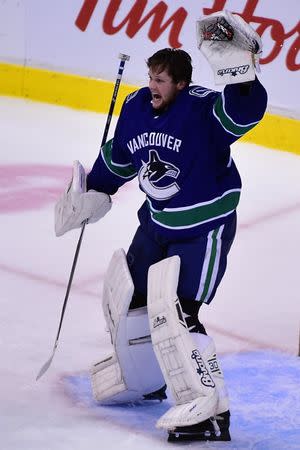 Jan 18, 2019; Vancouver, British Columbia, CAN; Vancouver Canucks goaltender Thatcher Demko (35) signals the referee after losing his helmet during the third period against the Buffalo Sabres at Rogers Arena. Mandatory Credit: Anne-Marie Sorvin-USA TODAY Sports