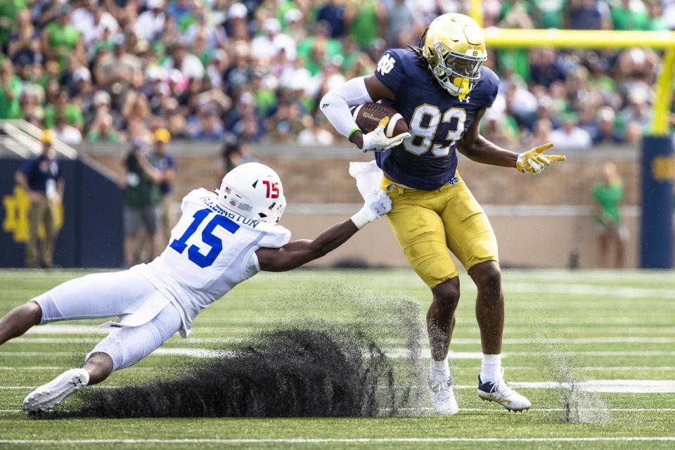 Notre Dame's Jayden Thomas (83) breaks a tackle attempt by Tennessee State's Kenyon Garlington (15) during the first half of an NCAA college football game on Saturday, Sept. 2, 2023 in South Bend, Ind. (AP Photo/Michael Caterina)