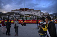 Visitors gather on a public square at the base of the Potala Palace in Lhasa in western China's Tibet Autonomous Region, as seen during a rare government-led tour of the region for foreign journalists, Tuesday, June 1, 2021. Long defined by its Buddhist culture, Tibet is facing a push for assimilation and political orthodoxy under China's ruling Communist Party. (AP Photo/Mark Schiefelbein)