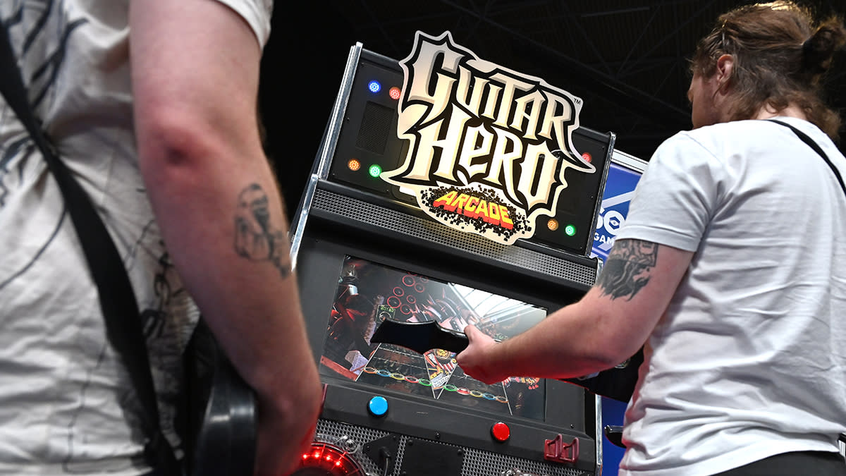  People playing Guitar Hero Arcade. 