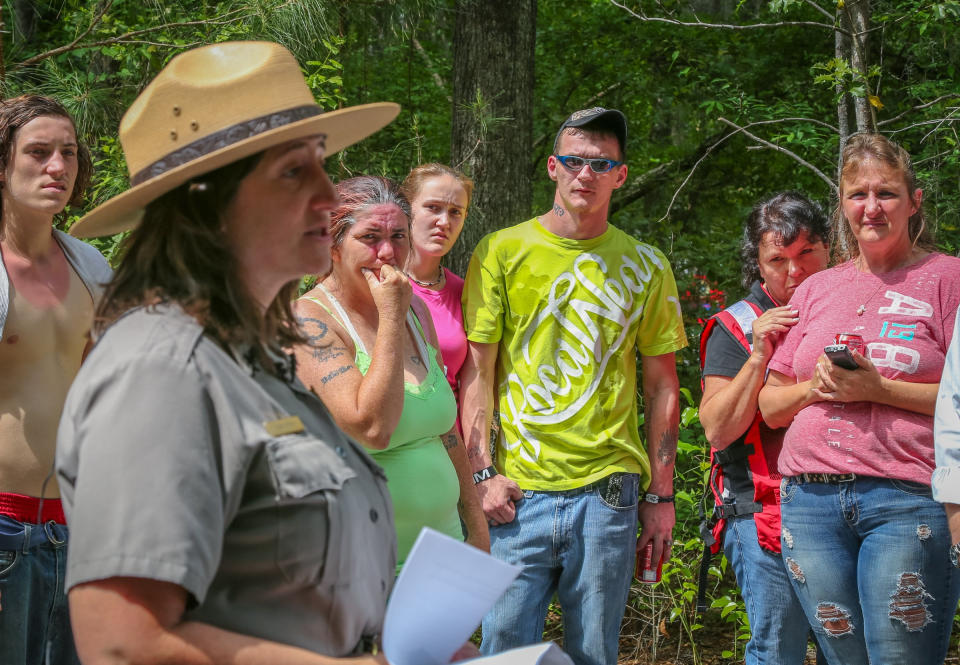 Dana Soehn, a spokeswoman for Congaree National Park, speaks about the search for a father and his two children who haven't been heard from sending out a text Saturday that they were lost in the vast woods and swamps of the park, near Columbia, S.C. Officials closed the park Monday afternoon so they could fully concentrate on finding 43-year-old J.R. Kimbler, his 10-year-old son, Dakota, and 6-year-old daughter, Jade. On the far right is Tammy Ballard, mother of Dakota and Jade. (AP Photo/The State, Tim Dominick)