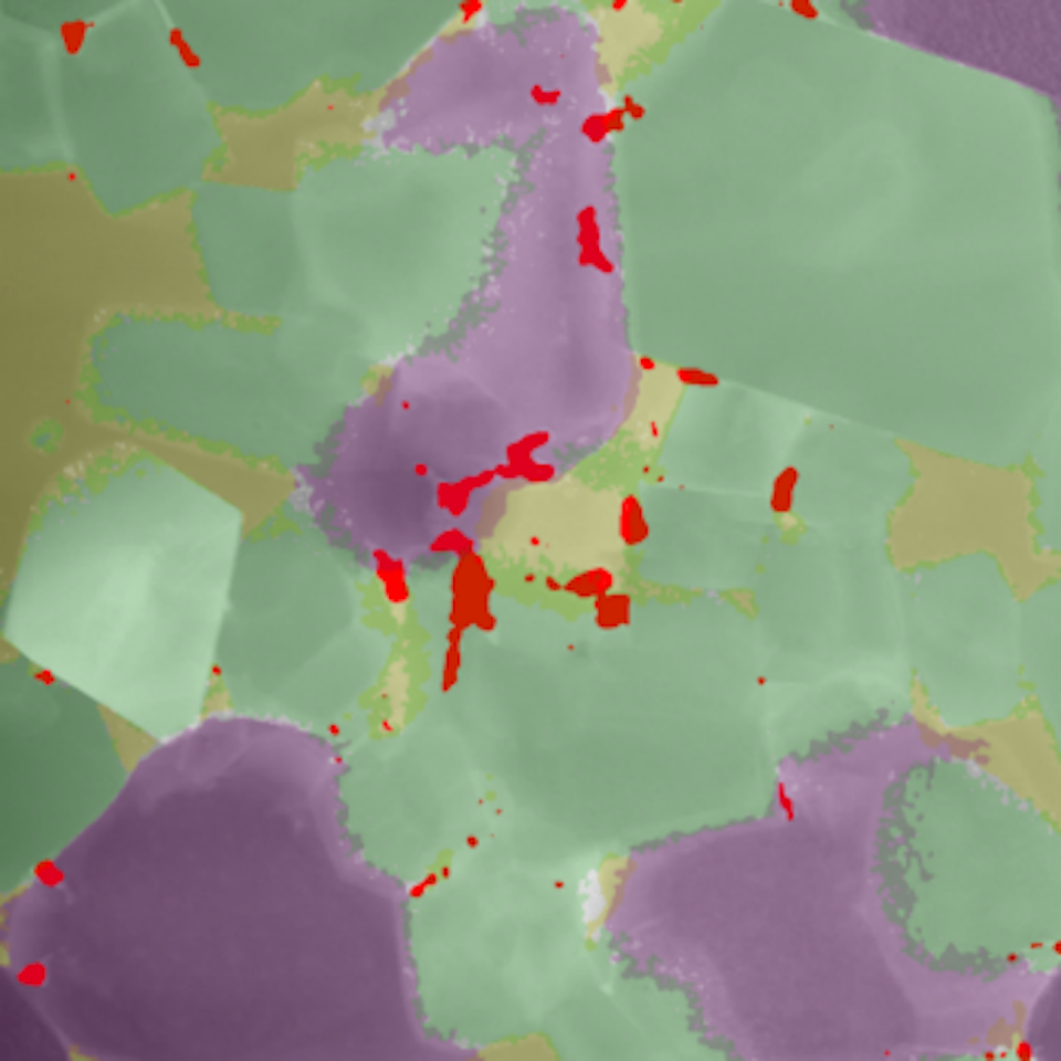 A close-up look at the baked minerals, showing olivine (yellow), periclase (purple), spinel (green) and a new uranium mineral (red). Image width is about 1/25th of that of a human hair. Grant Douglas, Author provided