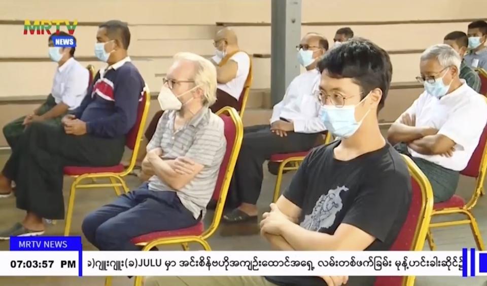 In this image taken from video by Myanmar state broadcaster MRTV, Japanese national Toru Kubota, front, and Australian Sean Turnell, center, are shown seated during a ceremony inside the Insein prison in Yangon, Myanmar on Thursday, Nov. 17, 2022. Myanmar’s military-controlled government says it is releasing and deporting an Australian academic, a Japanese filmmaker, an ex-British diplomat and an American as part of a broad prisoner amnesty marking the country’s National Victory Day. (MRTV via AP)