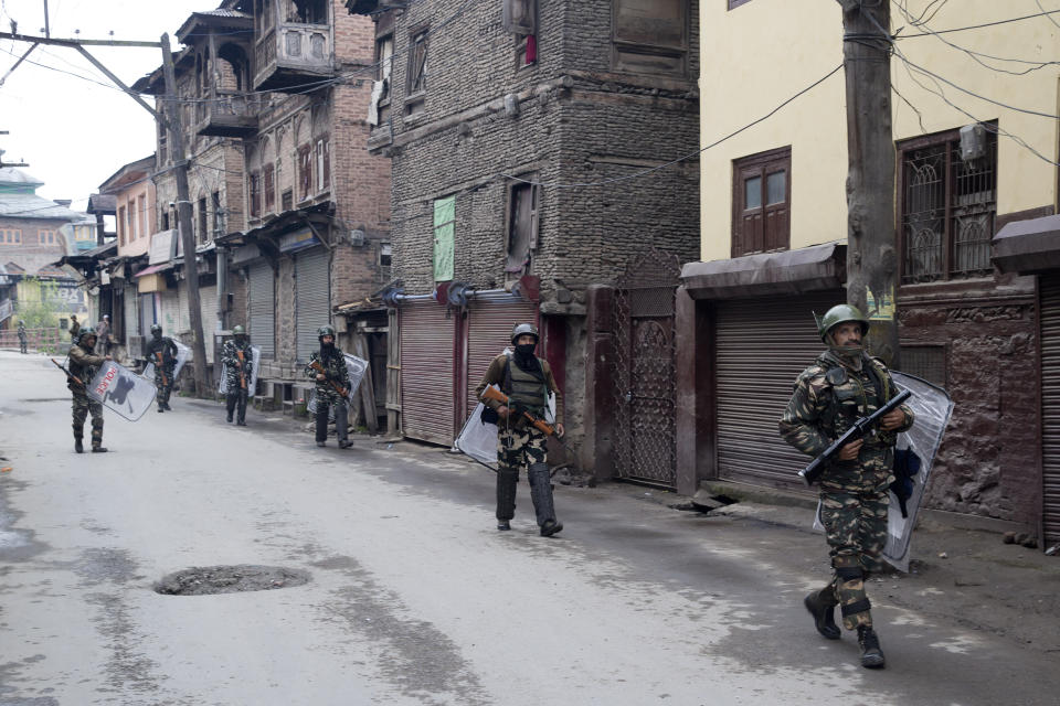 FILE - In this April 18, 2019, file photo, Indian paramilitary soldiers patrol a deserted street during the second phase of India's general elections, in Srinagar, Indian controlled Kashmir, after Kashmiri separatist leaders who challenge India's sovereignty over the disputed region called for a boycott of the vote. In the world’s largest democracy, few issues reach as broad a consensus as Kashmir, that the Muslim-majority region must remain part of Hindu-majority India. Indian Prime Minister Narendra Modi is using this, and a February attack on Indian paramilitary forces in Kashmir, to consolidate the Hindu vote in India’s five-week elections that conclude May 21 to bolster his campaign-slogan claim to be India’s chowkidar, or watchman. (AP Photo/ Dar Yasin)