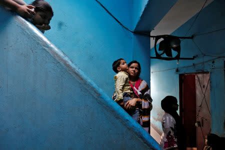 Gausiya, 30, from the Qureshi community poses for a picture in her home behind a butcher shop, ordered to close, following regulations imposed by newly elected Uttar Pradesh State Chief Minister, Yogi Adityanath, in Lucknow, India, April 4, 2017. Picture taken April 4, 2017. REUTERS/Cathal McNaughton