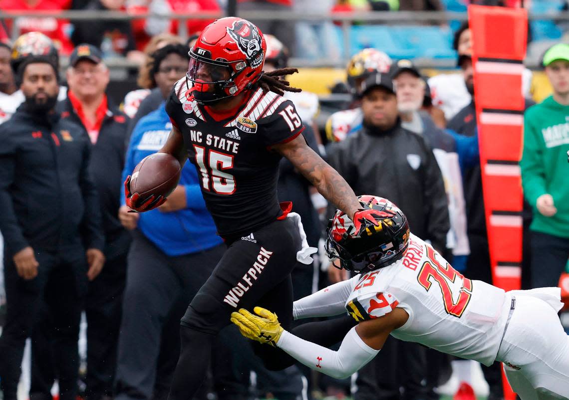 N.C. State wide receiver Keyon Lesane (15) gets by Maryland defensive back Beau Brade (25) during the first half of N.C. State’s game against Maryland in the Duke’s Mayo Bowl at Bank of America Stadium in Charlotte, N.C., Friday, Dec. 30, 2022.