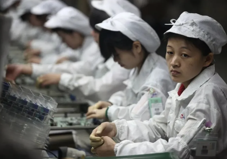 Workers on an assembly line at the Foxconn factory. Image: Taken from Daily People