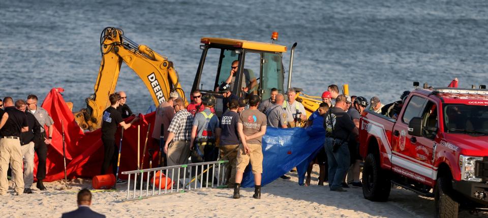 Emergency personnel work to recover an 18-year-old man from Maine who was killed in a sand hole collapse at the end of East Bonita Way in the Ocean Beach III section of Toms River, NJ, Tuesday evening, May 17, 2022.  His 17-year-old sister was also in the hole, but rescued.