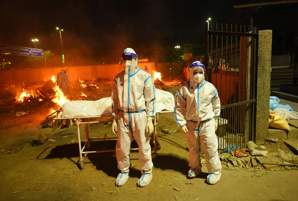 Image: Covid-19 victims are cremated at Seemapuri crematorium in New Delhi. (Amal KS / Hindustan Times / Getty Images)