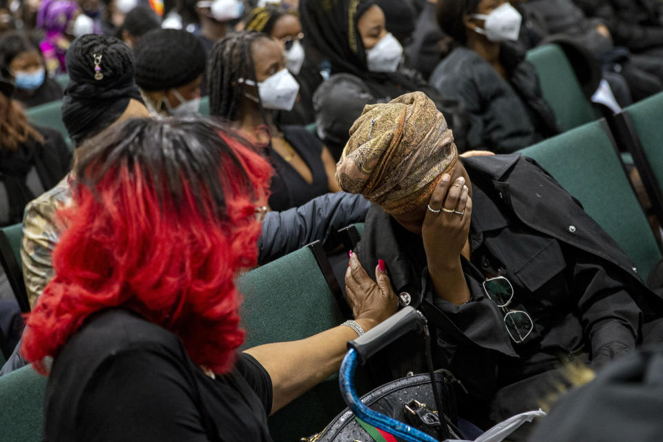 Community members react during the funeral for Patrick Lyoya at the Renaissance Church of God in Christ Family Life Center in Grand Rapids, Mich. on Friday, April 22, 2022. The Rev. Al Sharpton demanded that authorities publicly identify the Michigan officer who killed Patrick Lyoya, a Black man and native of Congo who was fatally shot in the back of the head after a struggle, saying at Lyoya's funeral Friday: “We want his name!" (Cory Morse/The Grand Rapids Press via AP)