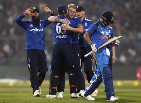 Cricket - India v England - Third One Day International - Eden Gardens, Kolkata, India - 22/01/2017. England's players celebrate the dismissal of India's captain Virat Kohli (R). REUTERS/Rupak De Chowdhuri