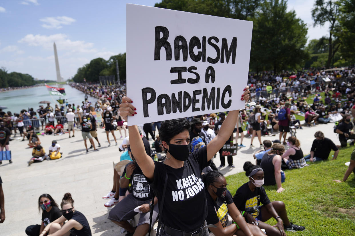 A participant at The March on Washington on Aug. 28, 2020, at the Lincoln Memorial in Washington, on the 57th anniversary of the Rev. Martin Luther King Jr.'s "I Have A Dream" speech. (Julio Cortez/AP)