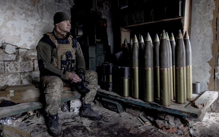 A Ukrainian soldier next to artillery shells inside a building near Bakhmut - Anadolu Agency/Anadolu