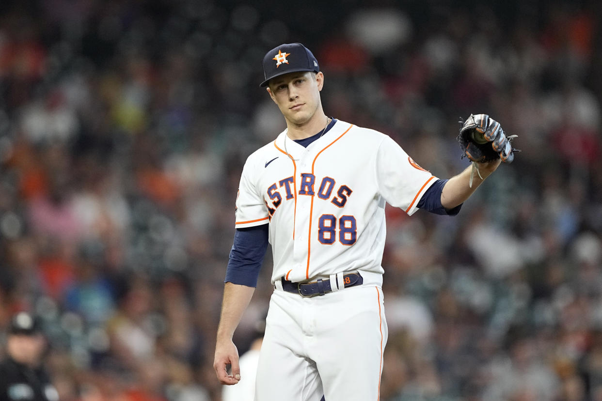 Houston Astros relief pitcher Phil Maton looks toward first base after giving up a single to his brother, Philadelphia Phillies Nick Maton, during the eighth inning of a baseball game Wednesday, Oct. 5, 2022, in Houston. (AP Photo/David J. Phillip)