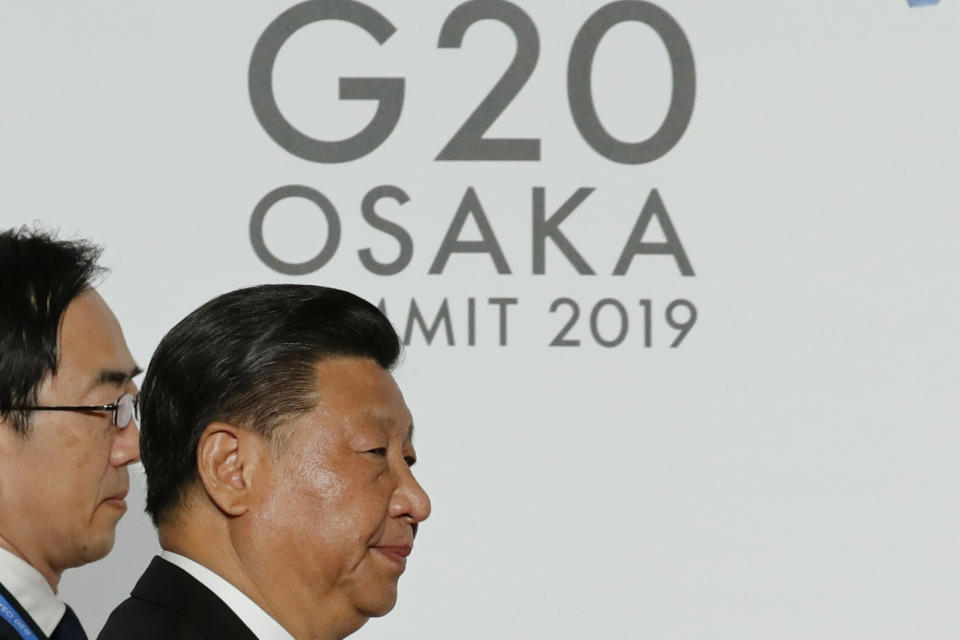 FILE - Chinese President Xi Jinping arrives for the welcome and family photo session at G-20 leaders summit in Osaka, Japan, on June 28, 2019. After a lengthy absence from major international gatherings, Chinese leader Xi Jinping is leaving his country's COVID bubble and venturing abroad next week into a dramatically changed world marked by rising confrontation. Xi will attend the G-20 meeting of industrial and emerging market nations in Indonesia followed by the Asia-Pacific Economic Cooperation summit in Thailand. (Kim Kyung-Hoon/Pool Photo via AP, File)