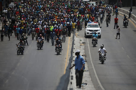 Demonstrators march along a street during a protest in Port-au-Prince, Haiti, July 14, 2018. REUTERS/Andres Martinez Casares
