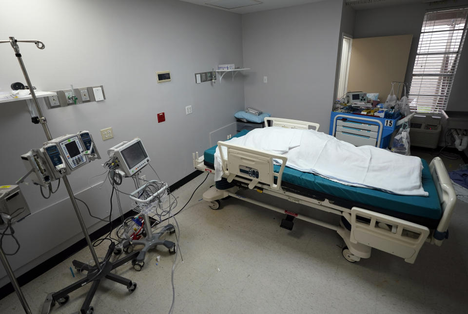 The body of a patent who died inside the Coronavirus Unit at United Memorial Medical Center is covered in sheets Monday, July 6, 2020, in Houston. Hospitalizations due to COVID-19 in the second-largest state in the U.S. have more than doubled in the last two weeks. (AP Photo/David J. Phillip)