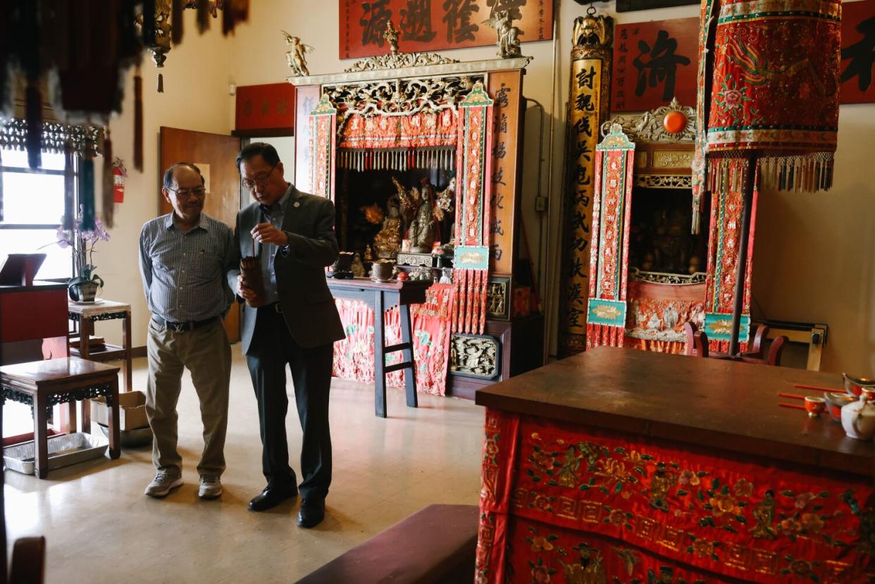 Derek Ma, left, and Thomas T. Lo inside the temple that draws worshipers to the Kong Chow Benevolent Assn.