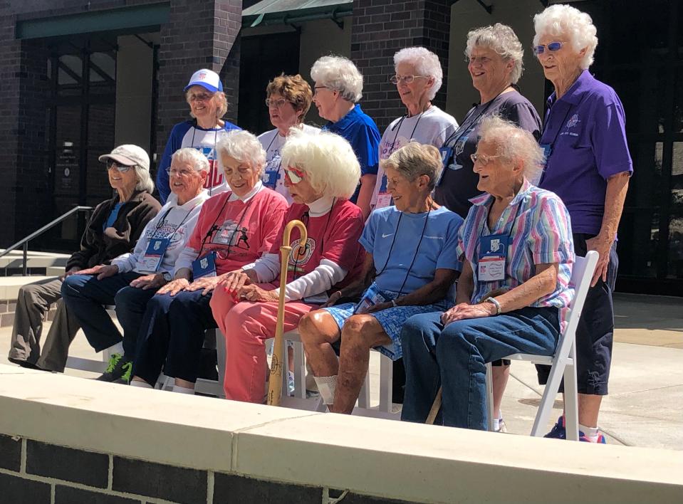 Players of the former All-American Girls Professional Baseball League gather for a group photo on Aug. 19, 2022, at The History Museum in South Bend.