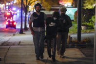 A man is detained by police during protests Friday, Oct. 9, 2020, in Wauwatosa, Wis. On Wednesday, District Attorney John Chisholm declined to charge Wauwatosa police Officer Joseph Mensah in the February fatal shooting of 17-year-old Alvin Cole outside a mall. (AP Photo/Morry Gash)