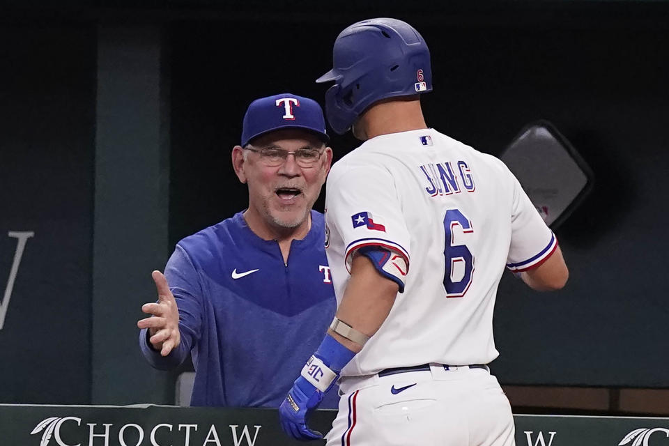 Texas Rangers' Josh Jung (6) is congratulated by manager Bruce Bochy (15) after hitting a two-run home run during the sixth inning of a baseball game against the Baltimore Orioles in Arlington, Texas, Wednesday, April 5, 2023. (AP Photo/LM Otero)